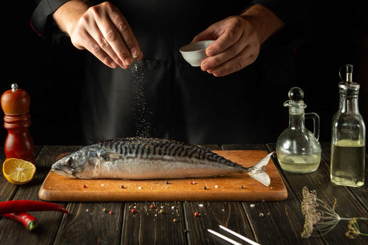 A,Fish,Chef,Prepares,Fresh,Mackerel,In,The,Kitchen.,Scomber
