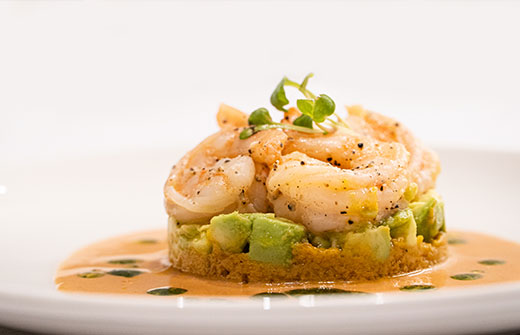 Exquisitely plated shrimp appetizer served as part of the world-class culinary journey on a Galapagos ultra-luxury cruise.