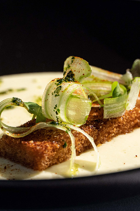 Gourmet Ecuadorian-international fusion cuisine, beautifully plated as part of the fine dining experience on the luxury Hermes Galapagos Cruise.