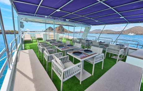 Al-fresco dining and seating area on the sundeck of the Monserrat Yacht Galapagos Cruise.