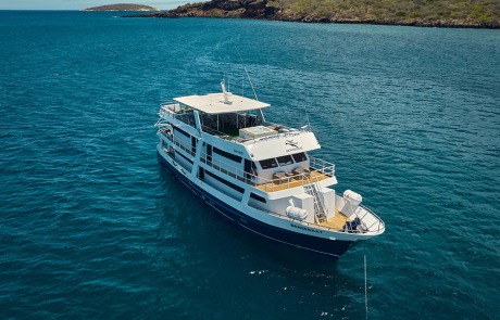 Diagonal exterior view showcasing the First-Class Monserrat Yacht on a Galapagos Cruise.