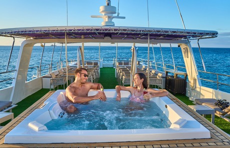 Guests enjoying the Jacuzzi on the Sun Deck of the Monserrat Yacht Galapagos Cruise.