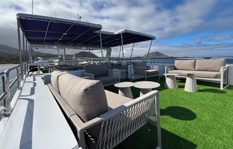 Comfortable seating area in a secondary lounge on the Monserrat Yacht Galapagos Cruise.