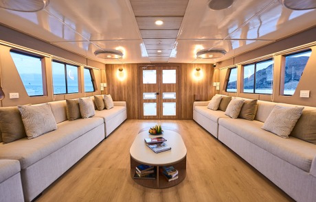 Interior view of the spacious Main Lounge on the Monserrat Yacht Galapagos Cruise.