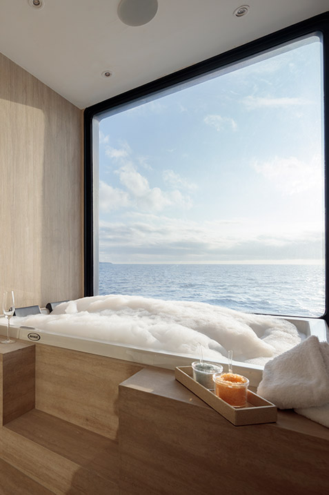 Luxury suite bathroom featuring a private jacuzzi tub on the Hermes Galapagos Catamaran