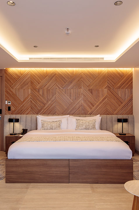 Interior view of the King Suite, showing a large bed and elegant decor on the Hermes luxury catamaran