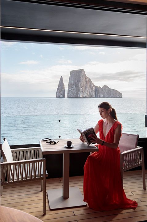 Guests enjoying the private balcony with ocean view attached to a suite on the Hermes Galapagos Luxury Cruise
